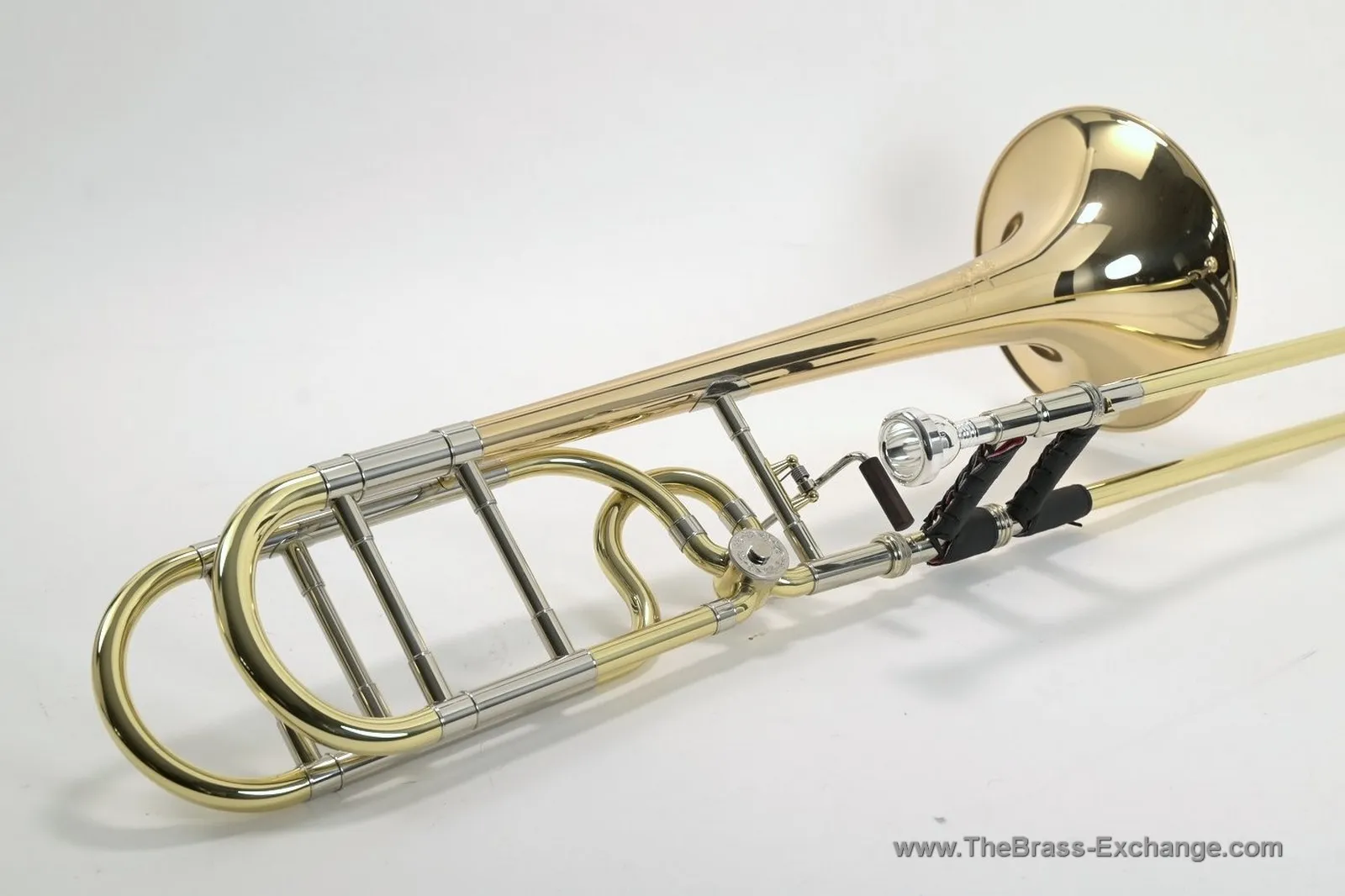 Shires gold brass intermediate tenor trombone showing open-wrap tubing, rotary valve, and handgrip