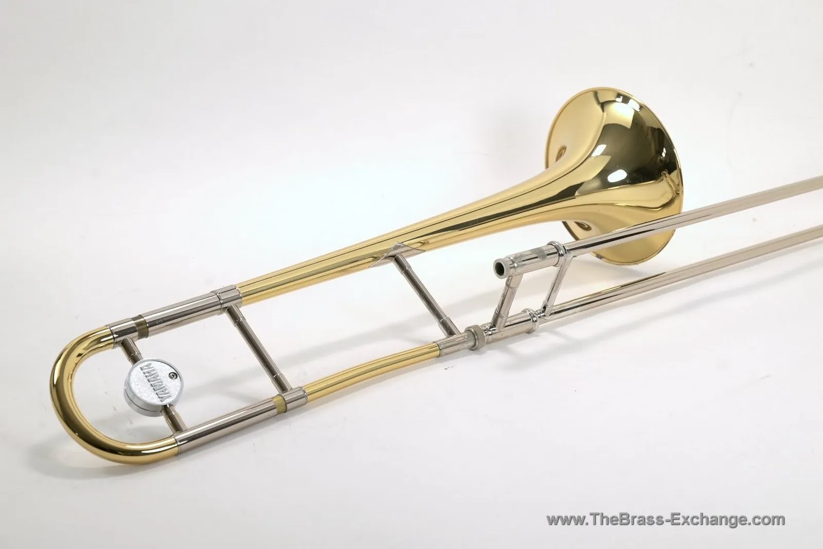 Yamaha YSL-691 trombone side view showing yellow brass bell, tuning slide, Yamaha counterweight, and handslide grips